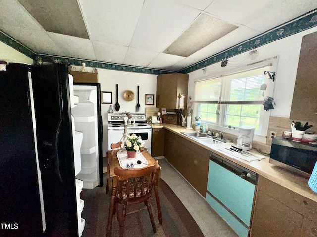 410 High St, Norlina, NC 27563 - kitchen with freestanding refrigerator, white range with electric cooktop, dishwasher, stainless steel microwave, and light countertops