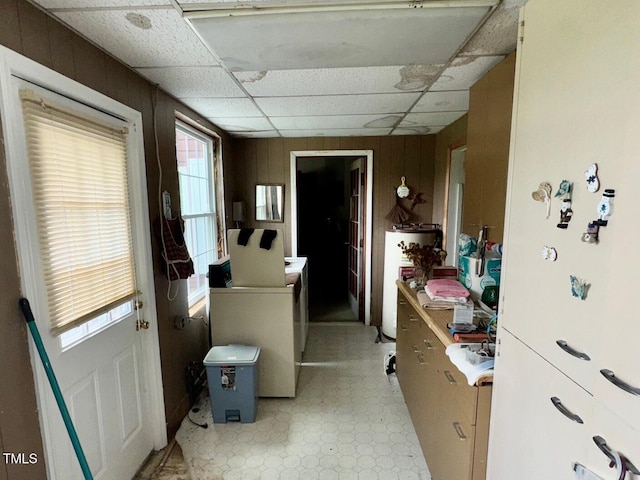 410 High St, Norlina, NC 27563 - kitchen featuring water heater, light floors, wooden walls, a paneled ceiling, and washer / clothes dryer