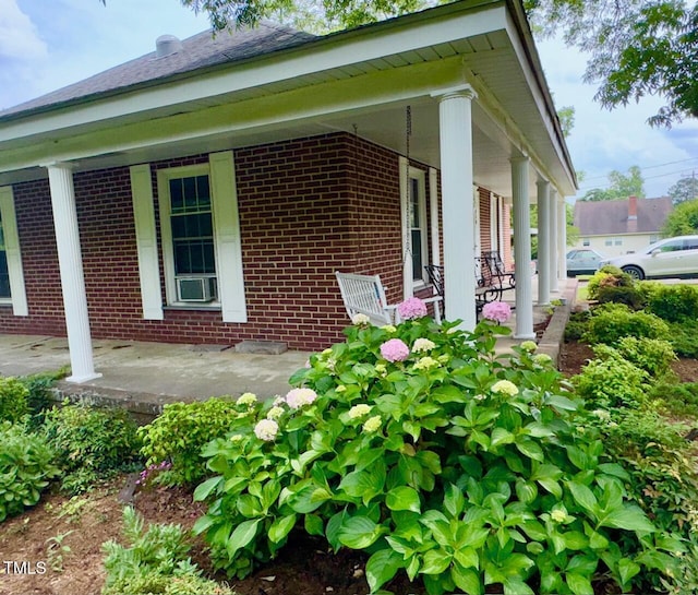 410 High St, Norlina, NC 27563 - view of side of property featuring brick siding, a porch, and cooling unit