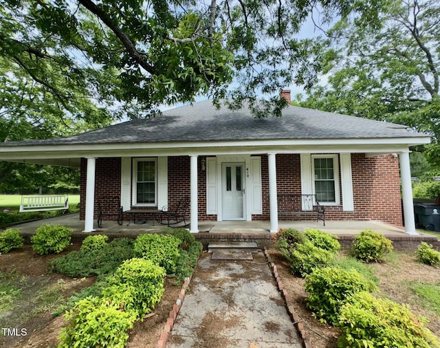 410 High St, Norlina, NC 27563 - single story home with a porch, a chimney, brick siding, and roof with shingles