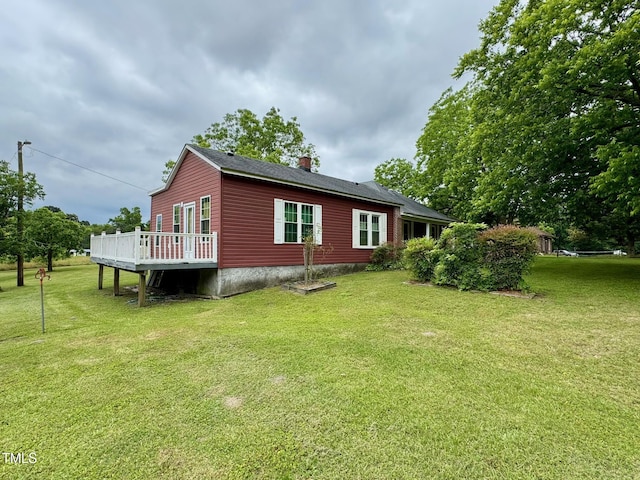 410 High St, Norlina, NC 27563 - rear view of house featuring a deck, a chimney, and a yard