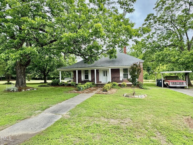 410 High St, Norlina, NC 27563 - view of front facade featuring a chimney, a front lawn, driveway, and brick siding