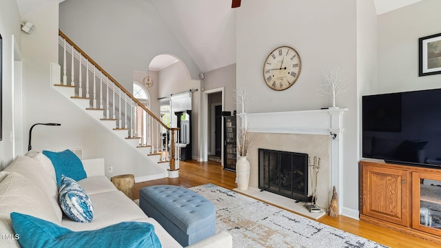 5 Wake Forest Ct, Southern Pines, NC 28387 - living area featuring wood finished floors, high vaulted ceiling, a fireplace, and stairs