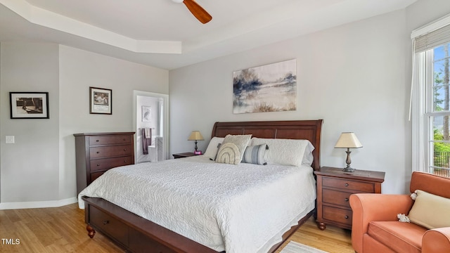 5 Wake Forest Ct, Southern Pines, NC 28387 - bedroom with light wood finished floors, connected bathroom, a ceiling fan, and a tray ceiling