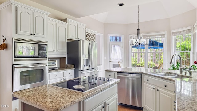 5 Wake Forest Ct, Southern Pines, NC 28387 - kitchen with appliances with stainless steel finishes, a chandelier, light stone countertops, and white cabinets
