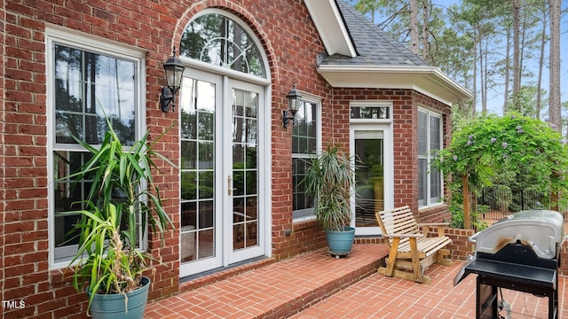 5 Wake Forest Ct, Southern Pines, NC 28387 - doorway to property featuring brick siding, french doors, roof with shingles, and a patio area