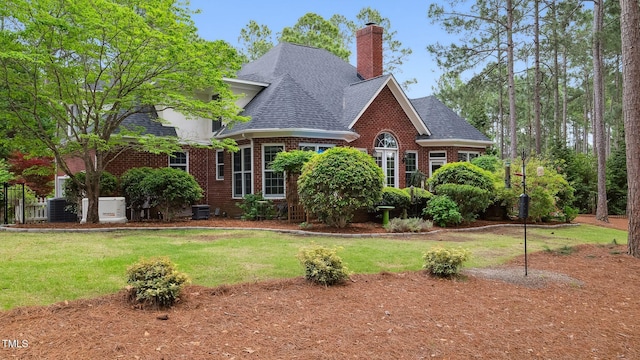 5 Wake Forest Ct, Southern Pines, NC 28387 - view of front of house featuring brick siding, a shingled roof, a front yard, and a chimney