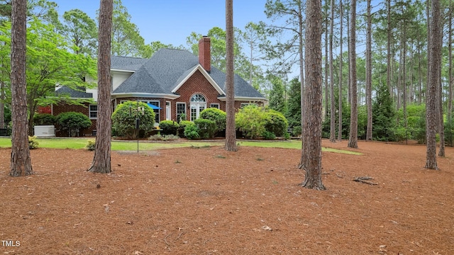 5 Wake Forest Ct, Southern Pines, NC 28387 - view of front of home with a chimney, roof with shingles, and brick siding