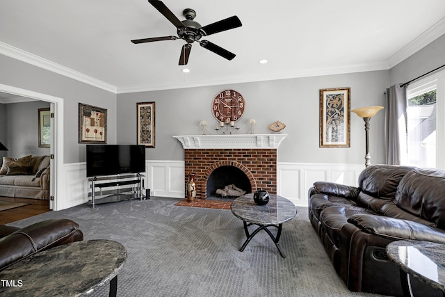 5013 Wheatridge Dr, Fuquay Varina, NC 27526 - living room featuring a ceiling fan, ornamental molding, a wainscoted wall, a decorative wall, and a brick fireplace