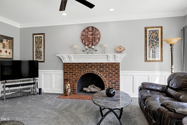 5013 Wheatridge Dr, Fuquay Varina, NC 27526 - carpeted living area with ceiling fan, ornamental molding, a wainscoted wall, a decorative wall, and a fireplace