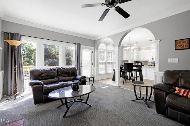 5013 Wheatridge Dr, Fuquay Varina, NC 27526 - living room featuring arched walkways, decorative columns, a ceiling fan, crown molding, and a chandelier