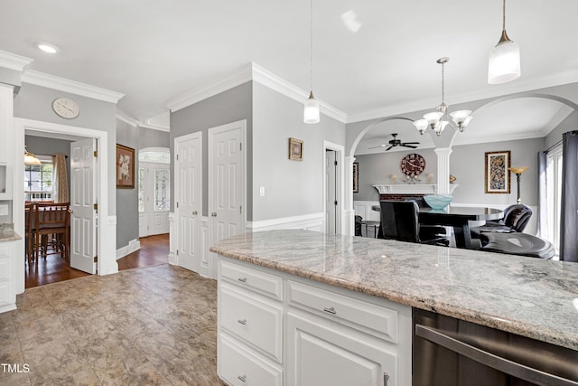 5013 Wheatridge Dr, Fuquay Varina, NC 27526 - kitchen with arched walkways, ceiling fan, ornamental molding, light stone countertops, and white cabinets