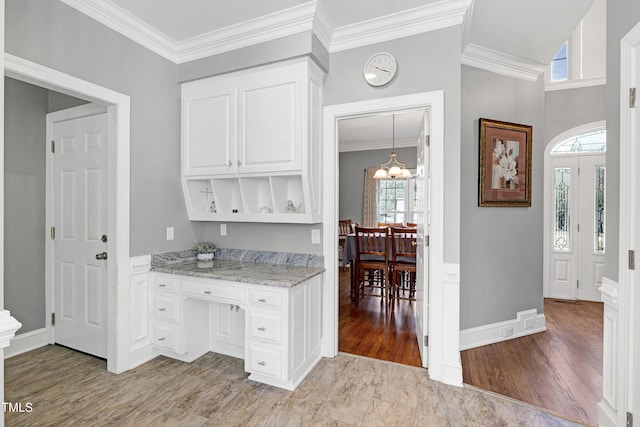 5013 Wheatridge Dr, Fuquay Varina, NC 27526 - bar area with a chandelier, ornamental molding, and light wood-type flooring