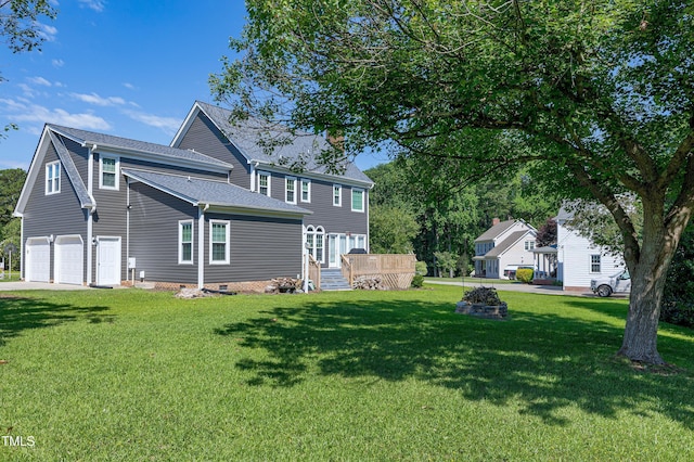 5013 Wheatridge Dr, Fuquay Varina, NC 27526 - back of property featuring a garage, a yard, driveway, roof with shingles, and crawl space