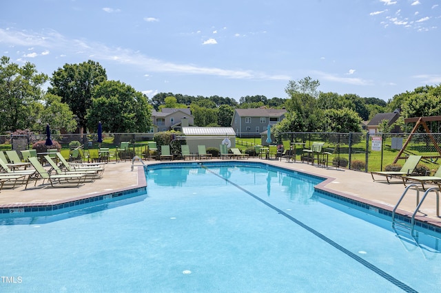 5013 Wheatridge Dr, Fuquay Varina, NC 27526 - community pool with a patio and view of scattered trees