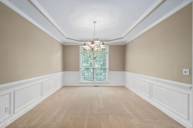 315 Birdwood Ct, Cary, NC 27519 - spare room with a raised ceiling, a chandelier, ornamental molding, wainscoting, and light colored carpet