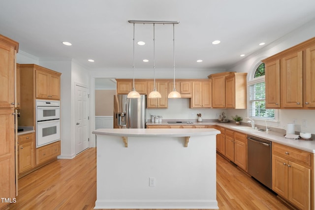 315 Birdwood Ct, Cary, NC 27519 - kitchen with appliances with stainless steel finishes, crown molding, a kitchen island, light wood-style flooring, and a kitchen bar
