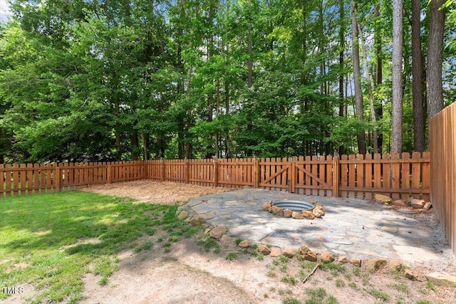 1016 Goldmist Ln, Durham, NC 27713 - fenced backyard featuring an outdoor fire pit