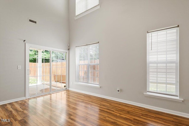 1016 Goldmist Ln, Durham, NC 27713 - unfurnished room featuring wood finished floors, healthy amount of natural light, and a towering ceiling