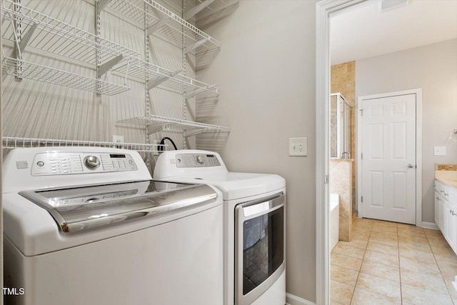 1016 Goldmist Ln, Durham, NC 27713 - washroom with washing machine and clothes dryer and light tile patterned floors
