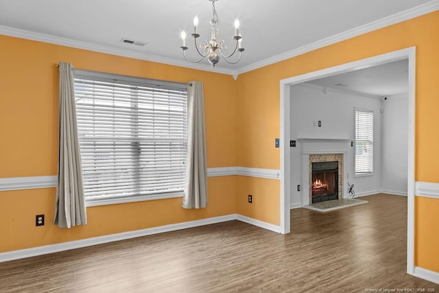 3118 High Plains Dr, Hope Mills, NC 28348 - unfurnished living room with wood finished floors, a chandelier, crown molding, and a warm lit fireplace