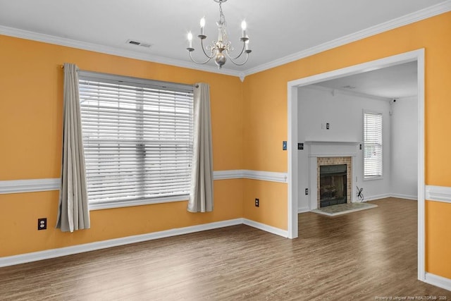 3118 High Plains Dr, Hope Mills, NC 28348 - unfurnished living room with wood finished floors, a chandelier, ornamental molding, and a fireplace with raised hearth