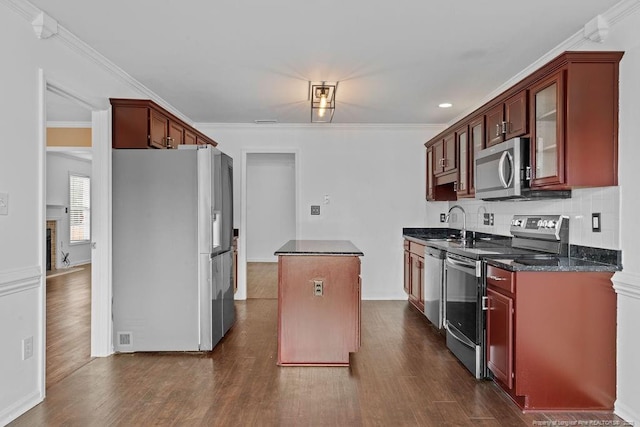 3118 High Plains Dr, Hope Mills, NC 28348 - kitchen with appliances with stainless steel finishes, a center island, dark wood finished floors, backsplash, and ornamental molding