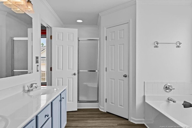 3118 High Plains Dr, Hope Mills, NC 28348 - full bathroom featuring double vanity, a garden tub, wood finished floors, a stall shower, and crown molding