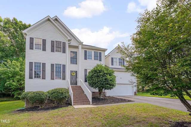 5308 Bentgrass Dr, Raleigh, NC 27610 - view of front facade with asphalt driveway, an attached garage, and a front yard
