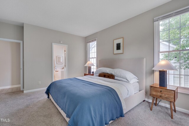 5308 Bentgrass Dr, Raleigh, NC 27610 - carpeted bedroom featuring baseboards and ensuite bathroom