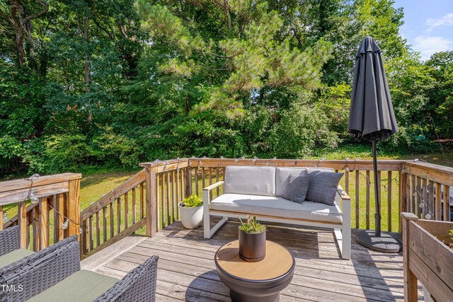 5308 Bentgrass Dr, Raleigh, NC 27610 - wooden terrace with outdoor lounge area and view of wooded area