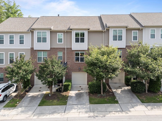 4124 Sykes St, Cary, NC 27519 - view of front facade featuring brick siding, a garage, concrete driveway, and roof with shingles