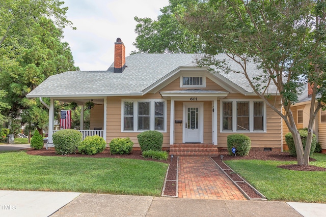601 E Franklin St, Raleigh, NC 27604 - bungalow-style house with a front lawn, a chimney, a shingled roof, and crawl space