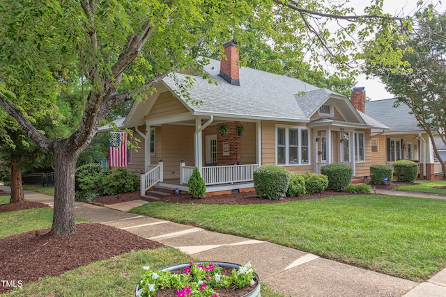 601 E Franklin St, Raleigh, NC 27604 - view of front of property with covered porch, a front yard, crawl space, a chimney, and a shingled roof