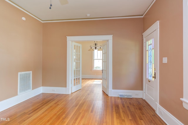 601 E Franklin St, Raleigh, NC 27604 - entrance foyer with ornamental molding, light wood-style floors, and a chandelier