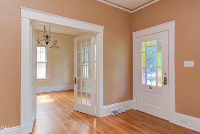 601 E Franklin St, Raleigh, NC 27604 - foyer entrance with light wood-style flooring and ornamental molding