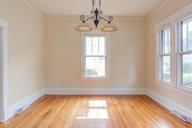 601 E Franklin St, Raleigh, NC 27604 - spare room with light wood-style flooring, a chandelier, and crown molding