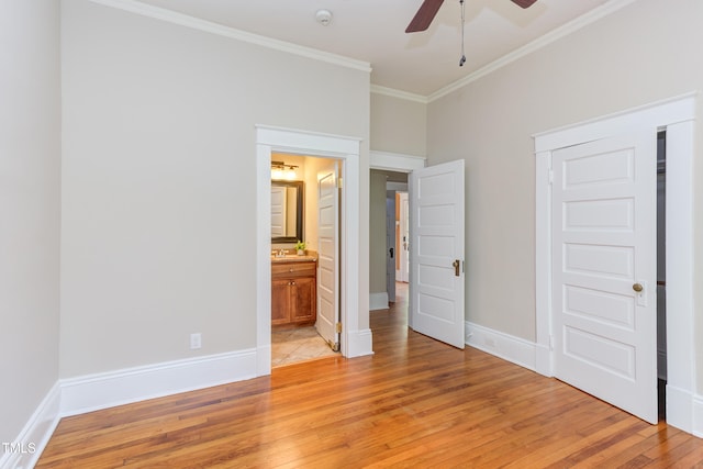 601 E Franklin St, Raleigh, NC 27604 - unfurnished bedroom with light wood-style floors, crown molding, ensuite bathroom, and a ceiling fan