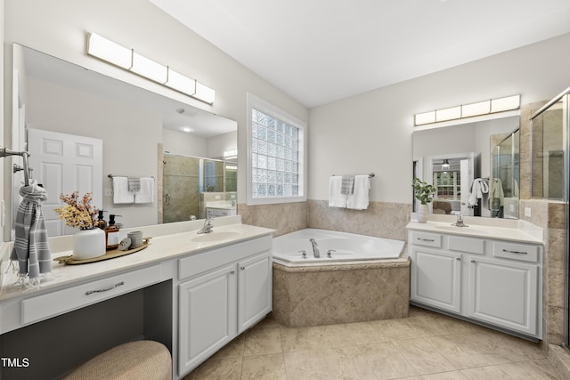 501 Ivyshaw Rd, Cary, NC 27519 - bathroom featuring a shower stall, two vanities, a bath, and tile patterned flooring
