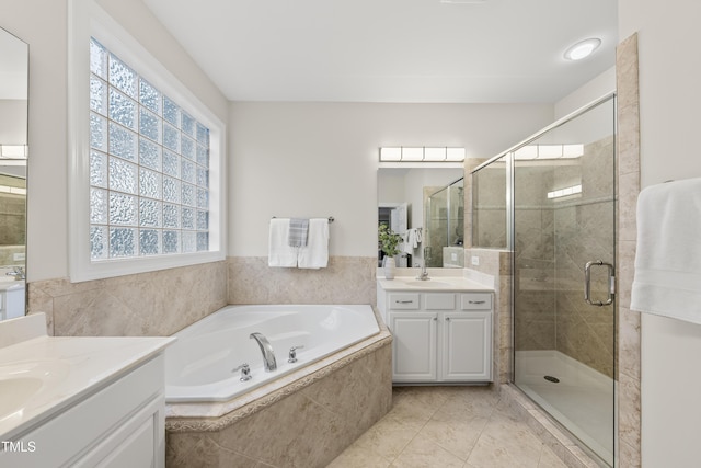 501 Ivyshaw Rd, Cary, NC 27519 - full bath featuring two vanities, a garden tub, a stall shower, and tile patterned flooring