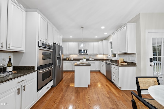 501 Ivyshaw Rd, Cary, NC 27519 - kitchen with appliances with stainless steel finishes, white cabinetry, decorative backsplash, and recessed lighting