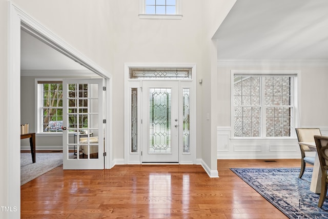 501 Ivyshaw Rd, Cary, NC 27519 - foyer entrance with healthy amount of natural light, wood finished floors, and crown molding