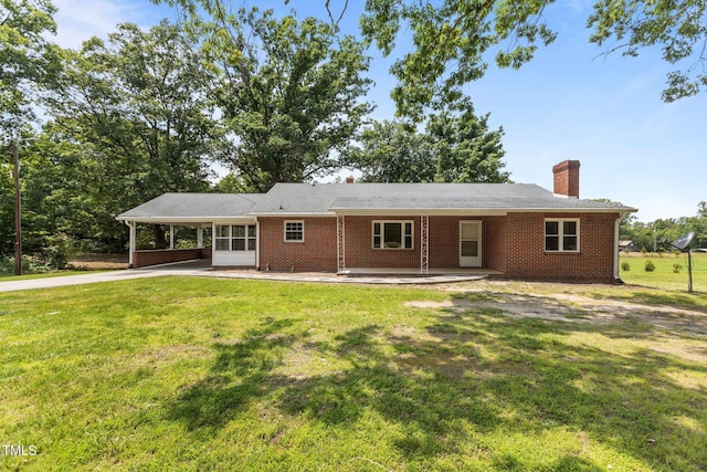2291 Gentry Ridge Rd, Roxboro, NC 27574 - view of front facade featuring a chimney, an attached carport, concrete driveway, and a front lawn