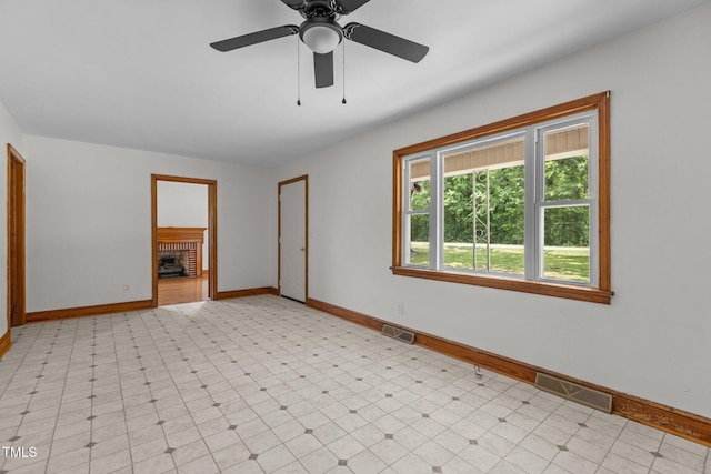 2291 Gentry Ridge Rd, Roxboro, NC 27574 - unfurnished room featuring a ceiling fan and a fireplace