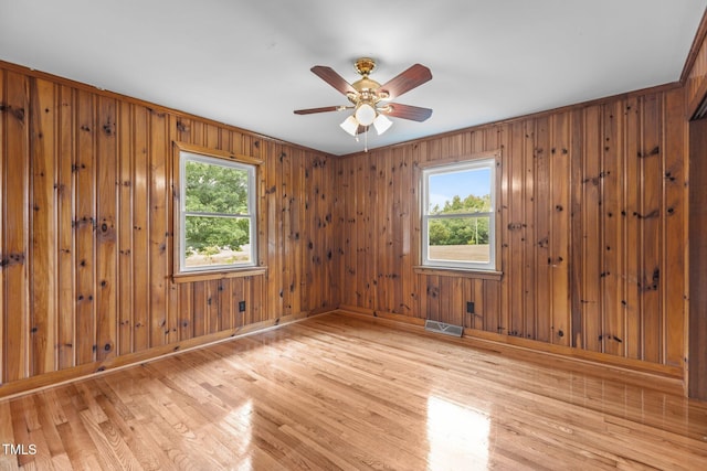 2291 Gentry Ridge Rd, Roxboro, NC 27574 - spare room with healthy amount of natural light, light wood-style flooring, ceiling fan, and wooden walls