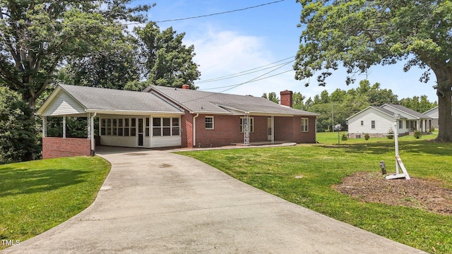 2291 Gentry Ridge Rd, Roxboro, NC 27574 - single story home with driveway, a sunroom, a chimney, a front lawn, and brick siding