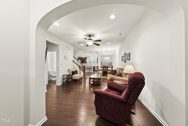 7235 Terregles Dr, Raleigh, NC 27617 - living room with a ceiling fan, stairs, arched walkways, dark wood finished floors, and recessed lighting