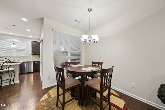 7235 Terregles Dr, Raleigh, NC 27617 - dining area with dark wood-style flooring, a chandelier, and recessed lighting