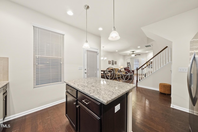 7235 Terregles Dr, Raleigh, NC 27617 - kitchen with dark wood-style floors, recessed lighting, pendant lighting, a ceiling fan, and light stone counters