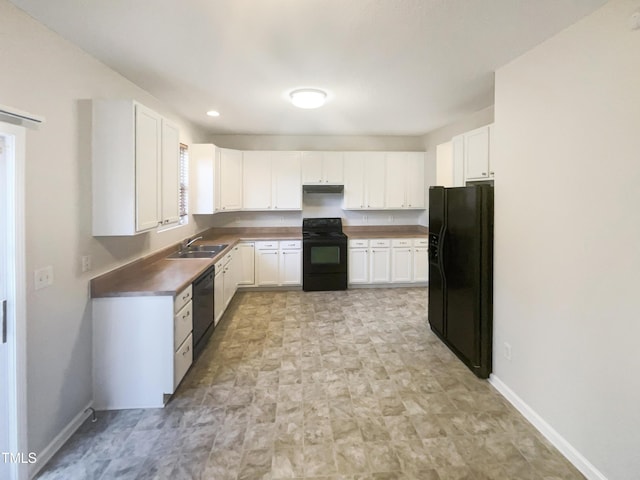 6701 Winding Arch Dr, Durham, NC 27713 - kitchen featuring black appliances, white cabinetry, stone finish flooring, and under cabinet range hood